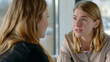 © VK Studio - Two women in a heartfelt conversation, capturing a moment of shared emotions in a bright, modern office environment.
