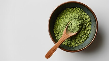 Wooden spoon with powdered matcha green tea in bowl, isolated on white. 