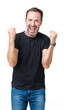 © Krakenimages.com - Handsome middle age hoary senior man over isolated background celebrating surprised and amazed for success with arms raised and open eyes. Winner concept.