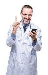 Canvas Print - Middle age senior hoary doctor man texting using smartphone over isolated background surprised with an idea or question pointing finger with happy face, number one