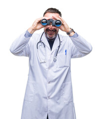 Wall Mural - Middle age senior hoary doctor man looking through binoculars isolated background with a happy face standing and smiling with a confident smile showing teeth