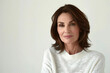 © Vlaskova - Beautiful mature confident woman in white sweater portrait on white background. Space for text