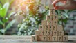 © Usman - Hand put the last wooden cubes on the top of a pyramid built by wood toy with idea symbol, and many question marks at the base, got idea from many questions