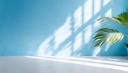 Wall Mural - Blurred shadow from palm leaves on the light blue wall. Minimal abstract background for product presentation. Spring and summer.