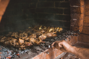 close-up view of gourmet meat and vegetables cooking on skewers with fire and barbecue