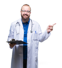 Wall Mural - Young doctor man holding clipboard over isolated background very happy pointing with hand and finger to the side