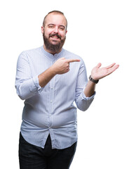 Canvas Print - Young caucasian hipster man over isolated background amazed and smiling to the camera while presenting with hand and pointing with finger.