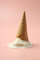 Poster - Melted ice cream in wafer cone on light pink background