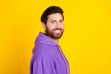 Wall Mural - Portrait of good mood satisfied man with stylish bristle dressed purple hoodie smiling at camera isolated on yellow color background