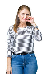 Canvas Print - Middle age mature beautiful woman wearing stripes winter sweater over isolated background mouth and lips shut as zip with fingers. Secret and silent, taboo talking