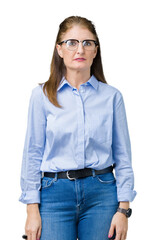 Wall Mural - Beautiful middle age mature business woman wearing glasses over isolated background Relaxed with serious expression on face. Simple and natural looking at the camera.