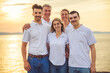 © Louis-Paul Photo - big family at beach on summer time, relax and support. Sunset, nature and smile with parents, kids walking by the sea for vacation