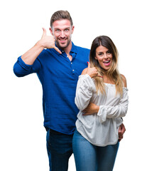 Wall Mural - Young couple in love over isolated background smiling doing phone gesture with hand and fingers like talking on the telephone. Communicating concepts.