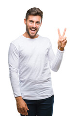 Canvas Print - Young handsome man over isolated background smiling with happy face winking at the camera doing victory sign. Number two.