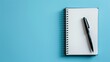 © LukaszDesign - Blank notebook and pen from above on light blue background with space for text idea for notes and organization