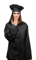 Poster - Young hispanic cook woman wearing chef uniform cover mouth with hand shocked with shame for mistake, expression of fear, scared in silence, secret concept