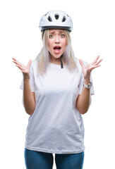 Sticker - Young blonde woman wearing cyclist security helmet over isolated background celebrating crazy and amazed for success with arms raised and open eyes screaming excited. Winner concept