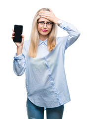 Sticker - Young beautiful blonde business woman showing screen of smartphone over isolated background stressed with hand on head, shocked with shame and surprise face, angry and frustrated