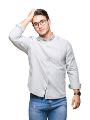 Wall Mural - Young handsome man wearing glasses over isolated background Smiling confident touching hair with hand up gesture, posing attractive