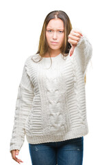 Sticker - Young beautiful caucasian woman wearing winter sweater over isolated background looking unhappy and angry showing rejection and negative with thumbs down gesture. Bad expression.