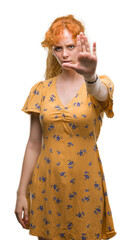 Sticker - Young redhead woman doing stop sing with palm of the hand. Warning expression with negative and serious gesture on the face.