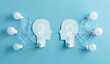 © eQuinox Studio - Two Paper Silhouettes with Lightbulbs Representing Ideas