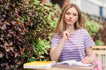 Sticker - Photo of pretty doubtful lady wear violet t-shirt sitting cafeteria preparing homework outdoors urban city street