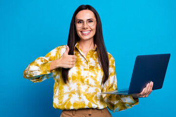 Poster - Photo of gorgeous adorable woman wear stylish clothes glasses modern gadget thumb up isolated on blue color background