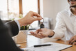 © Pormezz - Realtor agent giving a key of apartment to new owner after signed lease agreement.