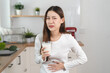 © Pormezz - lactose intolerance concept. Woman having a stomach ache from lactose intolerance.