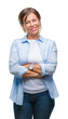 © Krakenimages.com - Middle age senior hispanic woman over isolated background happy face smiling with crossed arms looking at the camera. Positive person.