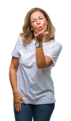 Sticker - Middle age senior hispanic woman over isolated background looking at the camera blowing a kiss with hand on air being lovely and sexy. Love expression.