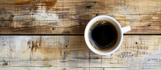 Poster - A white glass filled with black coffee set atop a wooden backdrop is ready to be enjoyed presenting a perfect copy space image