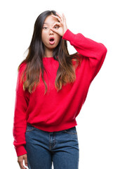 Poster - Young asian woman wearing winter sweater over isolated background doing ok gesture shocked with surprised face, eye looking through fingers. Unbelieving expression.