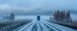© AI_images - A truck driving on a highway road during a foggy morning, with the road barely visible ahead and the surrounding landscape shrouded in mist.