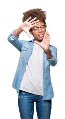 Wall Mural - Beautiful young african american woman wearing glasses over isolated background Smiling doing frame using hands palms and fingers, camera perspective