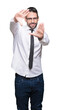 © Krakenimages.com - Young handsome business man wearing glasses over isolated background Smiling doing frame using hands palms and fingers, camera perspective