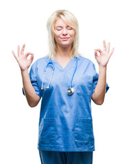 Poster - Young beautiful blonde doctor woman wearing medical uniform over isolated background relax and smiling with eyes closed doing meditation gesture with fingers. Yoga concept.