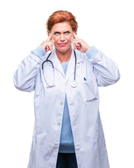 Sticker - Senior caucasian doctor woman wearing medical uniform over isolated background covering ears with fingers with annoyed expression for the noise of loud music. Deaf concept.