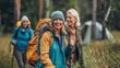© liliyabatyrova - A group of mature women are hiking through a forest, smiling and enjoying the scenery. They are all wearing backpacks and carrying hiking poles