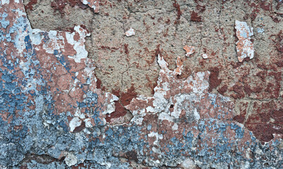 Texture of old rustic wall covered with gray and blue stucco. Multilayers of old paint on the wall. Textured background. Selective focus