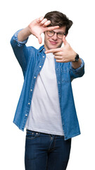 Wall Mural - Young handsome man wearing glasses over isolated background smiling making frame with hands and fingers with happy face. Creativity and photography concept.