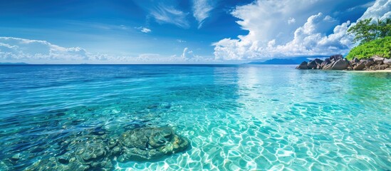 Poster - Stunning coastal view with clear turquoise waters offers a serene setting for a relaxing holiday with a magnificent copy space image.