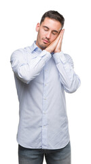 Canvas Print - Handsome young businessman sleeping tired dreaming and posing with hands together while smiling with closed eyes.