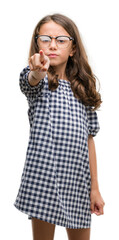 Sticker - Brunette hispanic girl wearing glasses pointing with finger to the camera and to you, hand sign, positive and confident gesture from the front