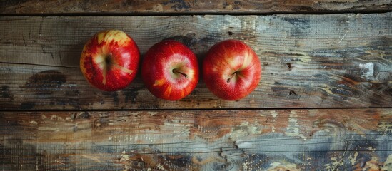 Leinwandbilder - Three apples arranged on a vintage wooden surface, with copy space image available.