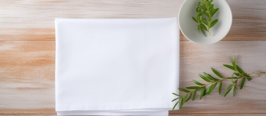Leinwandbilder - Flat lay with folded white kitchen napkin on a table, isolated background for mockups featuring copy space image, showcasing a minimal, modern aesthetic.