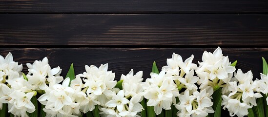 Aufkleber - White hyacinth flowers set on a black wooden table with copy space image.