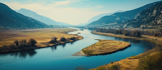 Wall Mural - A river meandering with a scenic view on one side and a vast and appealing blank space to be used for display or advertisement on the other side.