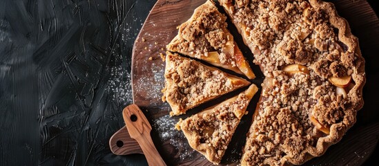 Poster - Top view of apple crumble pie slices on a wooden board with ample copy space image.